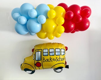 May include: A yellow school bus balloon with the text "Back-to-School" on the side. The bus balloon is surrounded by blue, yellow, and red balloons.