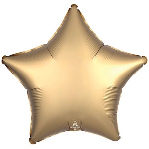 May include: A metallic gold star-shaped balloon. The balloon has five points and a shiny, reflective surface. The balloon is inflated and ready for use. The Anagram logo is visible on the bottom of the balloon.