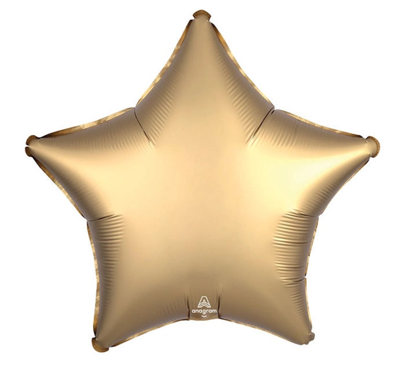 May include: A metallic gold star-shaped balloon. The balloon has five points and a shiny, reflective surface. The balloon is inflated and ready for use. The Anagram logo is visible on the bottom of the balloon.
