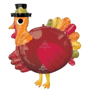 May include: Thanksgiving-themed turkey balloon in shades of red, orange, yellow, and green. The turkey is wearing a black pilgrim hat with a gold buckle. The balloon has a glossy finish and is designed for festive celebrations.