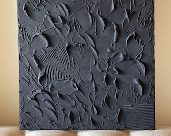 May include: A black and white abstract painting with a textured surface. The paint is applied in thick layers, creating a three-dimensional effect.