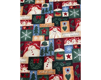 May include: A patchwork fabric with a winter holiday theme. The design features snowmen, snowflakes, Christmas trees, red hearts, and the text "Let it Snow" and "Snowmen Fall From Heaven". The color palette includes red, green, blue, and cream.