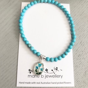 Turquoise beaded bracelet with a real Australian flower charm