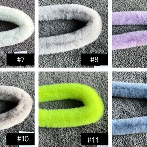 May include: Six different colours of faux fur trim, each in a circle shape. The colours are light grey, grey, purple, beige, lime green, and blue.