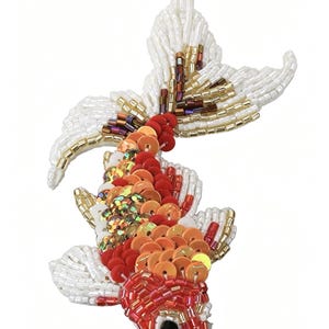 May include: A koi fish patch crafted with white, red, and orange beads and sequins. The body features overlapping orange and red circular sequins, while the head and fins are detailed with white, red, and gold glass seed beads. A black bead forms the eye.