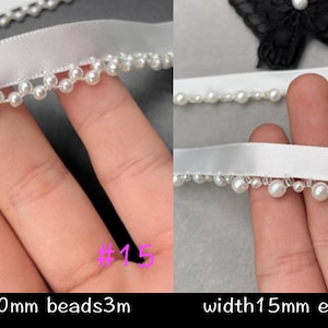 May include: Two white satin ribbons with a row of small, round, white beads along the edge. The ribbon on the left is 14mm wide with a 10mm edge and 3m of beads. The ribbon on the right is 15mm wide with a 5mm edge and 3m of beads.