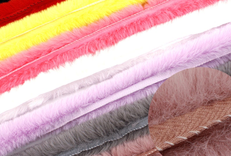 May include: A close-up of a variety of faux fur trim in different colors, including red, yellow, pink, lavender, gray, and brown. The trim is soft and fluffy, and it would be perfect for adding a touch of luxury to any project.