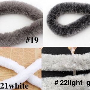 May include: Four samples of faux fur trim in different colors. The first sample is a dark gray fur trim labeled #19. The second sample is a lighter gray fur trim labeled #20. The third sample is a white fur trim labeled #21white. The fourth sample is a light gray fur trim labeled #22light gray.
