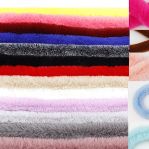 May include: Assortment of faux fur trim in various colors, including pink, blue, yellow, red, white, brown, and gray. The trim is approximately 1 inch wide and is perfect for adding a touch of luxury to any project.