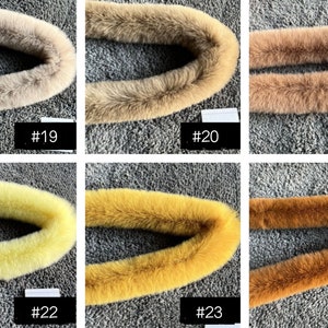 May include: Six different fur collars in various shades of brown, yellow, and beige. The collars are arranged in two rows of three, with each collar labelled with a number from 19 to 24.