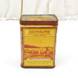 Puede incluir: Una lata rectangular y vintage de Germalyne con una etiqueta roja y amarilla. La etiqueta presenta el texto "GERMALYNE" y "100 pour 100 de germe int&eacute;gral de pur Froment". La lata tiene un aspecto r&uacute;stico y envejecido.