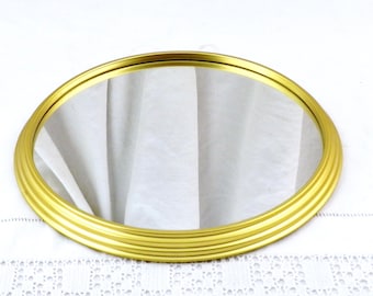 Peut inclure: Un miroir rond de couleur or avec un cadre décoratif à plusieurs couches.