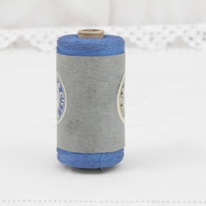 May include: A spool of blue thread with a white label that says "C.I.F."