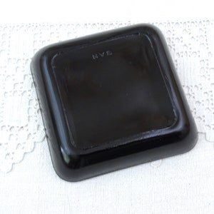 May include: Black square tray with a raised edge and the letters "RVS" stamped on the bottom.