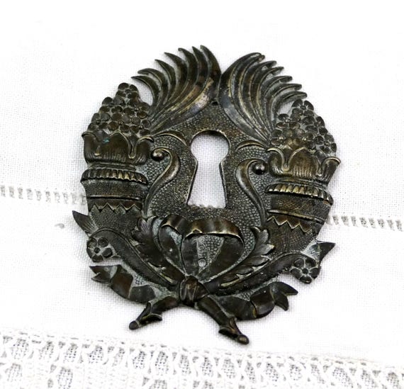 Antique Brass Lock Escutcheon with Ornate Symmetrical Scrollwork Floral Urns Crossed Ribbons and Decorative Keyhole Furniture Fitting