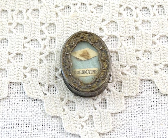 Small Antique French Religious Reliquary Pendant of Saint Germain in Oval Shaped Plated Metal with Glass, Retro Cabinet of Curiosity Item