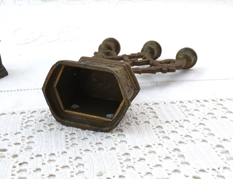 May include: A vintage brass candelabra with three candle holders. The candelabra has a decorative design and is in good condition.