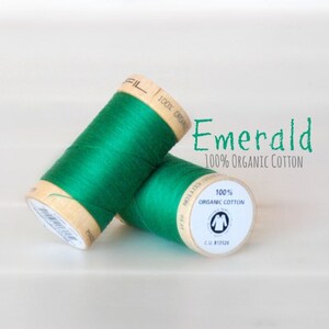 May include: Two spools of emerald green thread, labeled "100% Organic Cotton" and "Emerald".
