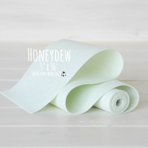 May include: A roll of light green, 100% pure wool felt, measuring 5 inches by 36 inches. The felt is rolled up and the label reads "Honeydew 5" x 36" 100% Pure Wool Felt".