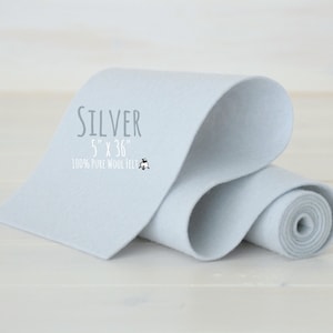 May include: A roll of light gray 100% pure wool felt, 5 inches wide and 36 inches long. The felt is labeled "SILVER".