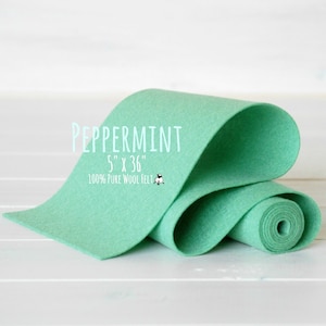 May include: A roll of 100% pure wool felt in a light green color called "Peppermint". The felt is 5 inches wide and 36 inches long.