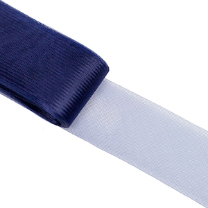 May include: A roll of navy blue tulle ribbon. The ribbon is soft and sheer, with a delicate texture.