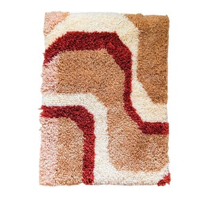May include: A rectangular, textured rug with a retro design. The rug features a pattern of wavy lines in shades of cream, brown, and red. The rug's texture appears soft and plush, suitable for a living room or bedroom.