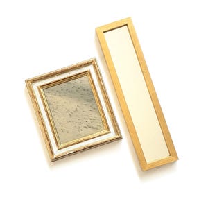 May include: A rectangular mirror with a gold frame and a tall, narrow vertical mirror with a gold frame. The rectangular mirror features a white inner border and a reflective surface, while the vertical mirror has a plain, light-colored surface.