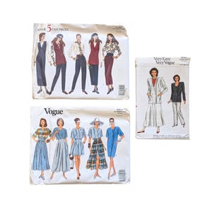 May include: Three vintage Vogue and Very Vogue sewing pattern envelopes. The patterns feature illustrations of women's clothing, including dresses, suits, and separates. The envelopes are white with colorful illustrations and text.