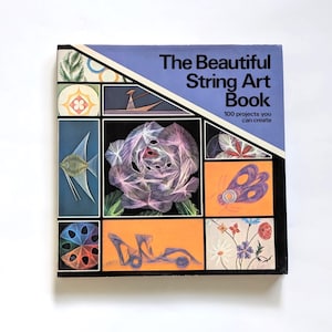 May include: A vintage book titled "The Beautiful String Art Book" with a blue cover and geometric designs. The cover features various string art examples, including a rose, butterfly, and fish. The book promises 100 projects.