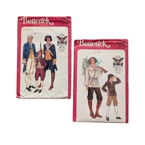 May include: Two vintage Butterick sewing pattern envelopes, numbers 4207 and 4209, featuring 1776 historical costume illustrations. The pink and white paper packets display drawings of colonial-era clothing, including coats, breeches, and shirts, with the text "Make It Real" and "The Fashion One" printed on the front.