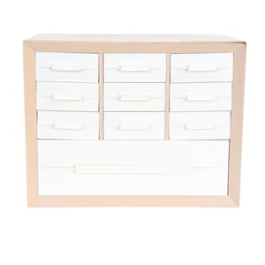 May include: A white ceramic mug with a black handle and the text "But first, coffee" in a black, handwritten-style font. The mug is on a white surface.