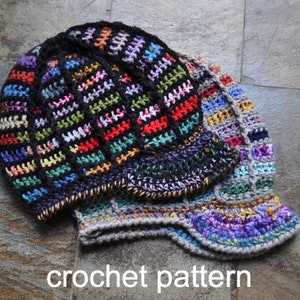 May include: A colorful crocheted hat with a black and multi-colored striped pattern. The hat has a brim and is folded over. The hat is made of yarn and is a handmade item.
