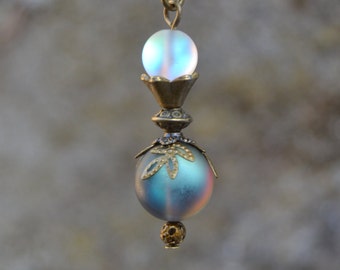 May include: A silver and iridescent glass bead necklace with a bronze chain and ornate metal accents.