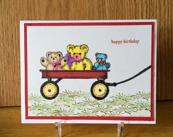 happy birthday card for child,  featuring teddy bears in a red wagon