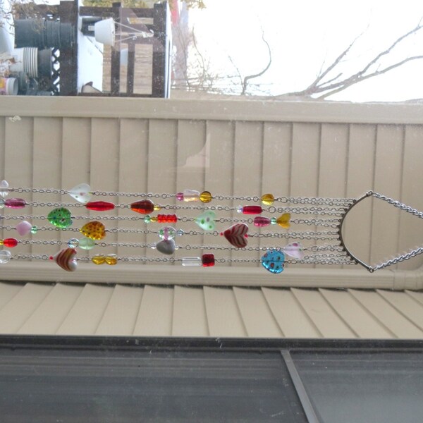 Suncatcher. Assorted hearts, crystals and glass of all shapes and sizes dangle from antique silver chain