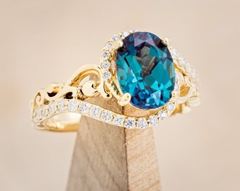 The scarlet Oval Lab created Alexandrite Engagement Ring With