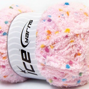 May include: A pink yarn ball with multi-colored speckles. The yarn is labeled "ICE Yarns" and "Super Soft".