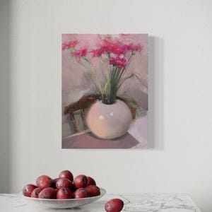 May include: An oil painting of a white vase with pink flowers. The vase is round and sits on a table. A bowl of red plums is in the foreground. The painting has a soft, impressionistic style.