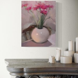 May include: An oil painting of a white, spherical vase holding a bouquet of pink flowers. The vase sits on a table, with a chair in the background. The painting has a soft, muted color palette.