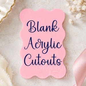 May include: A light pink acrylic cutout with a scalloped edge shape. The surface features dark blue text that reads Blank Acrylic Cutouts. The object has a smooth, flat finish and a rectangular form with rounded, wavy sides.