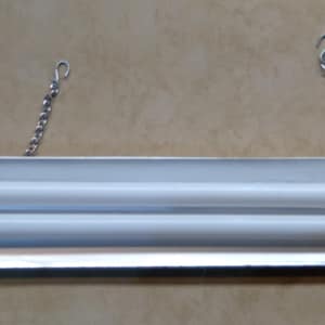 May include: A silver fluorescent light fixture with two bulbs hanging from a chain.