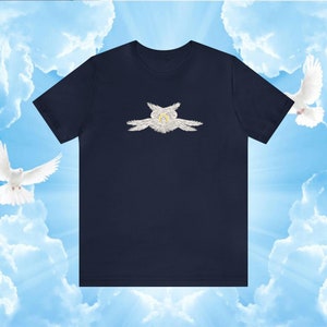 Op de afbeelding: Een marineblauw t-shirt met een witte engelprint op de voorkant. De engel heeft vleugels en een halo.