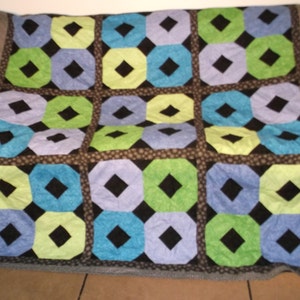 SALE on Geometric Twin Quilt in Turquoise, Blue Tones, and Green Tones with Black Centers and Black and White Sashing Material (SHIPS FREE)