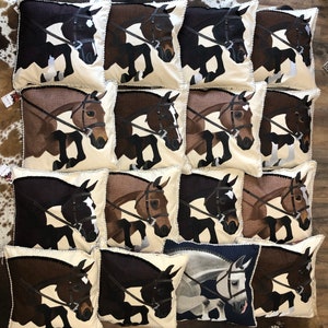 May include: A collection of 15 decorative cushion covers featuring a brown horse jumping over a fence. The cushions are arranged in a grid pattern on a wooden floor. The cushions are made of a soft, beige fabric with a brown horse design. The horse is depicted in a jumping position, with its legs extended and its head turned to the side. The cushions are a great way to add a touch of equestrian style to any room.