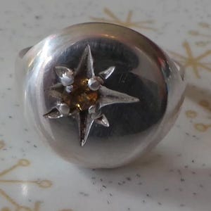 Sterling silver signet ring with carved star set with facetted cognac coloured tourmaline