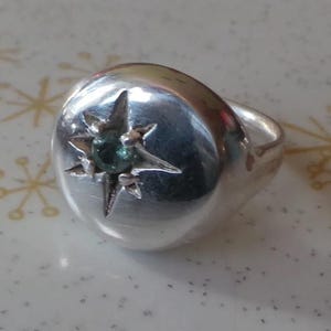 Sterling silver signet ring with carved star set with facetted aqua tourmaline