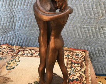 Tall Austin Productions brutalist sculpture man embrace woman