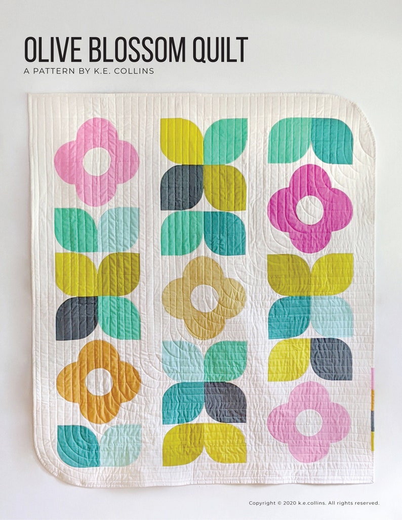 May include: A quilt pattern called "Olive Blossom Quilt" by K.E. Collins. The quilt features a white background with a repeating pattern of olive green, yellow, pink, teal, and gray flower shapes.