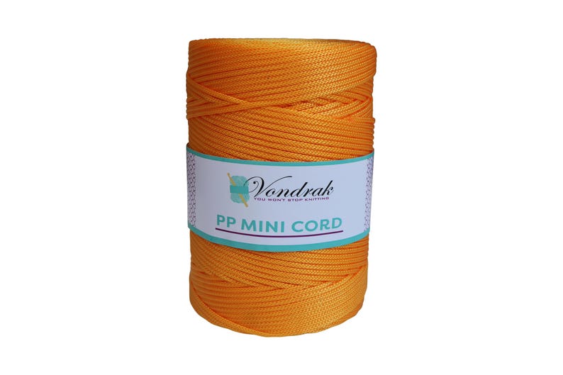 May include: A spool of vibrant orange PP Mini Cord. The label reads "Vondrak, You won't stop knitting". The cord is tightly wound, ideal for various craft projects.